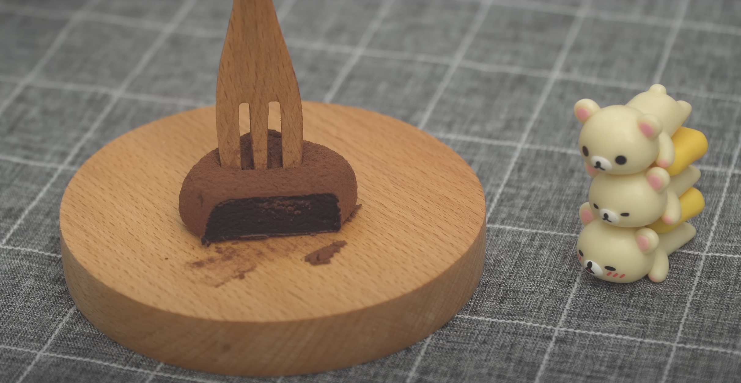 wooden fork stabbing into a chocolate truffle with a part cut off